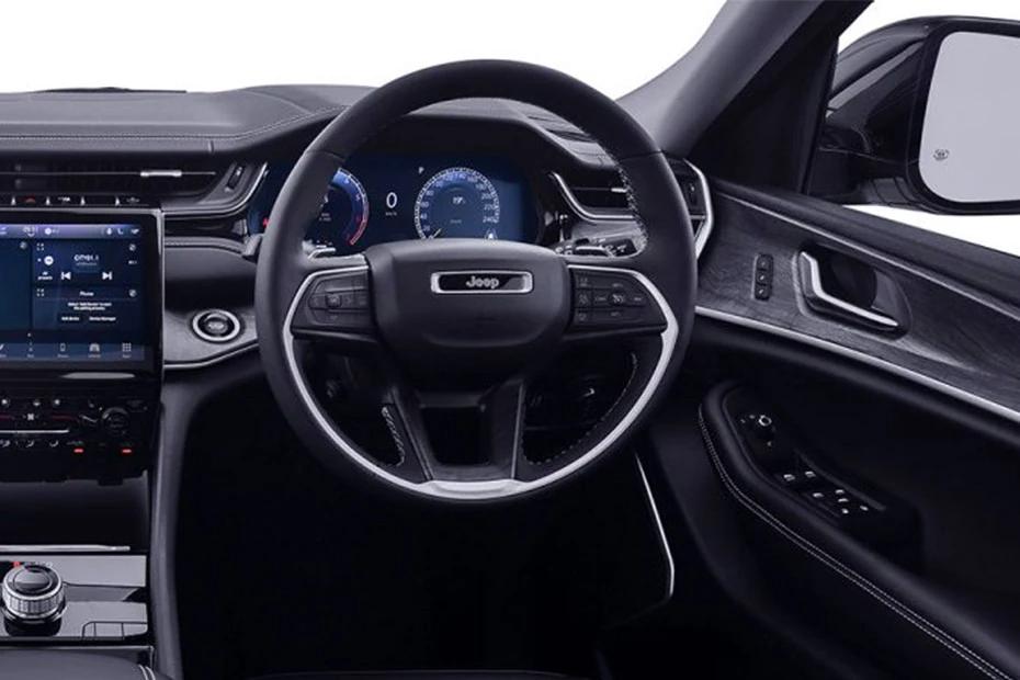 Jeep Grand Cherokee steering-wheel view highlighting grip, controls, and comfort