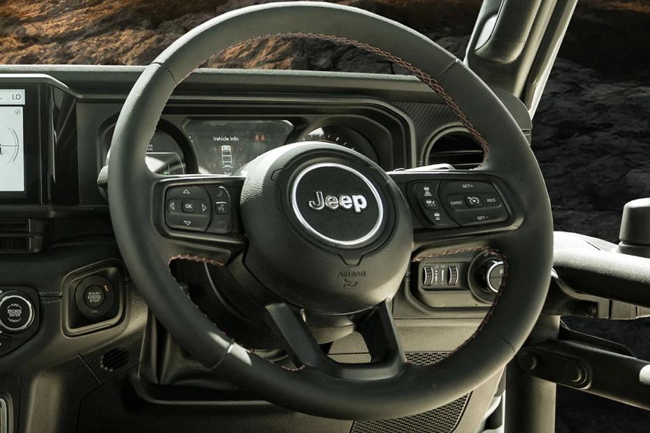 Jeep Wrangler steering-wheel view highlighting grip, controls, and comfort