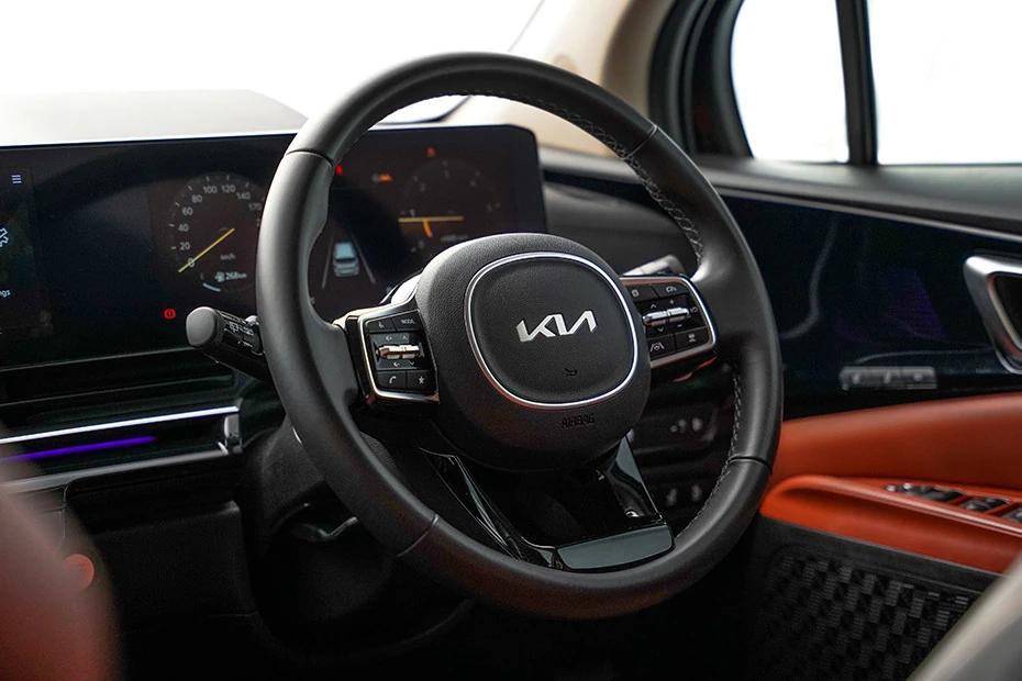 Kia Carnival steering-wheel view highlighting grip, controls, and comfort