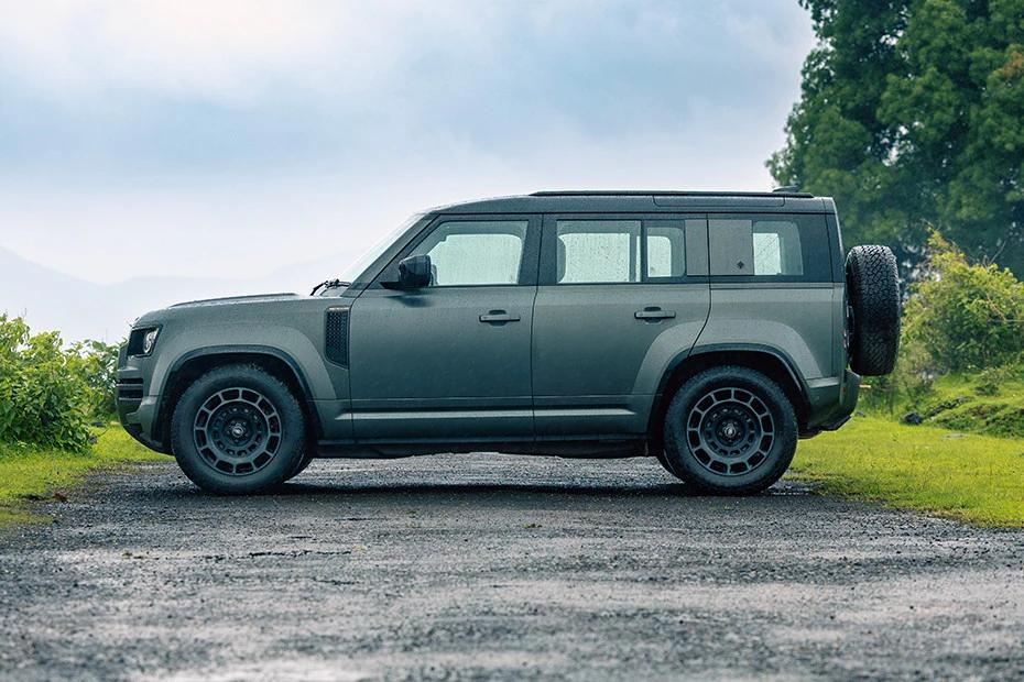 Land Rover Defender side-profile view highlighting roofline, stance, and proportion