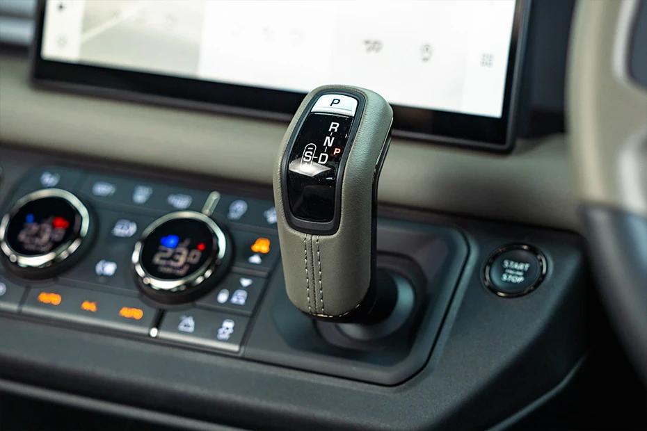 Land Rover Defender console-view view highlighting storage, controls, and ergonomics