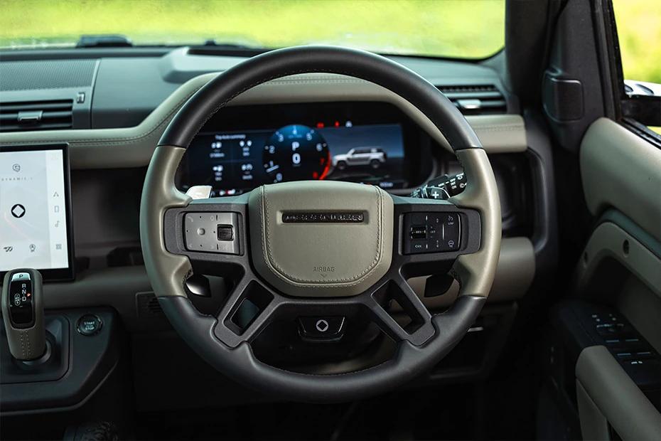 Land Rover Defender steering-wheel view highlighting grip, controls, and comfort